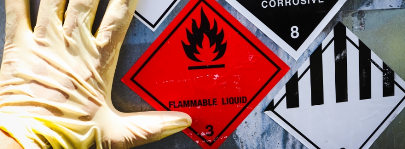 Hand next to flammable liquid warning sign